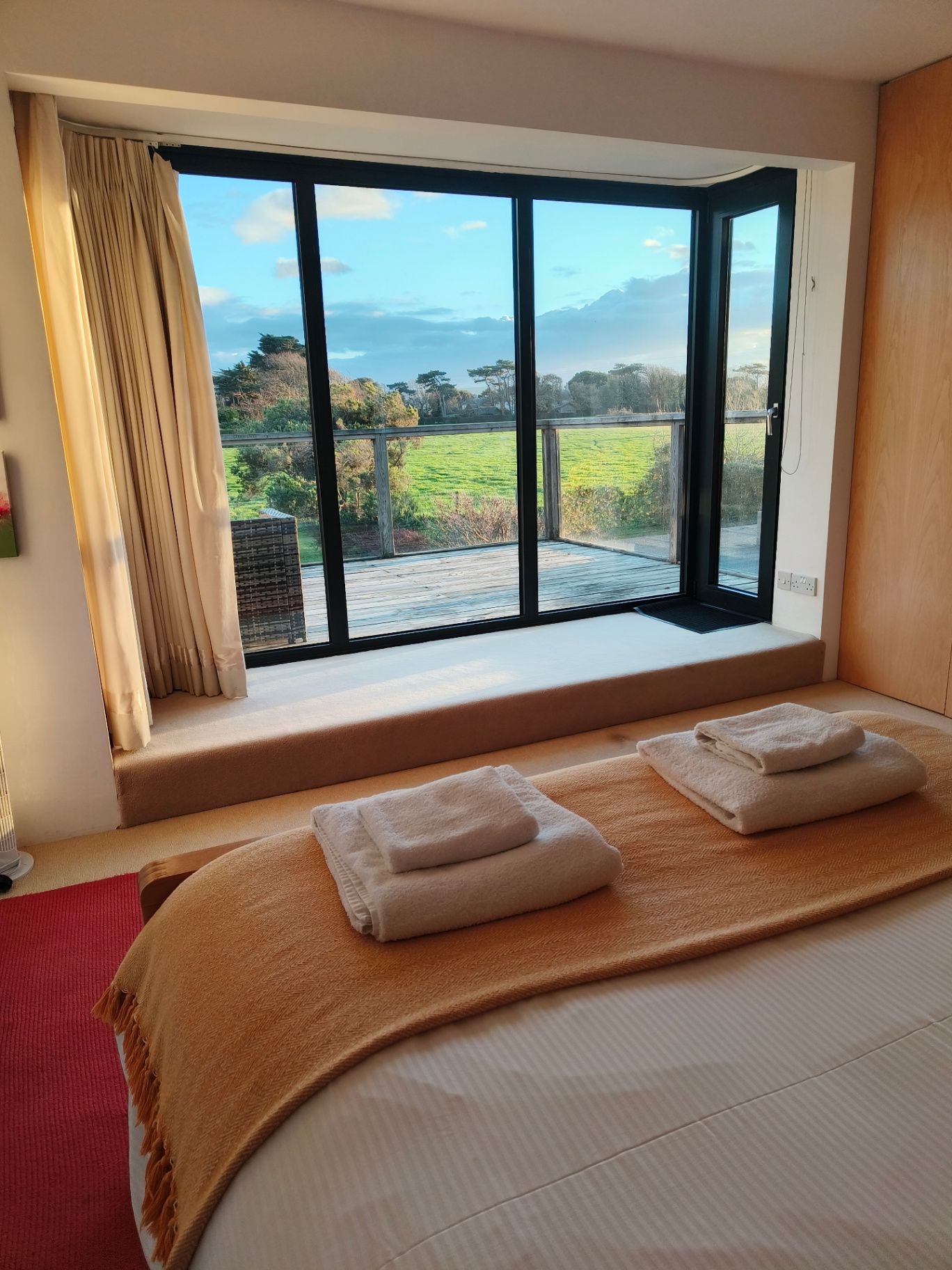 A peaceful retreat bedroom with a view towards the coast